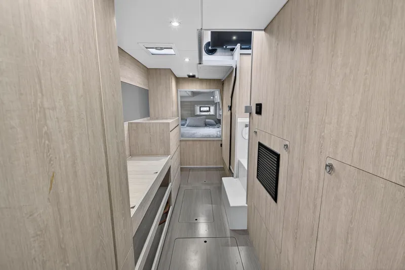 Yacht Photos Pics Interior of 2017 Leopard 43 Powercat, featuring modern wood paneling and cozy sleeping area.
