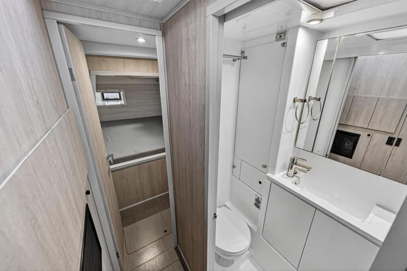  Yacht Photos Pics 2017 Leopard 43 Powercat interior bathroom with modern fixtures and wood accents.
