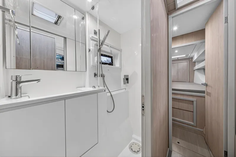  Yacht Photos Pics Modern bathroom interior on 2017 Leopard 43 Powercat yacht, featuring sleek fixtures and wood accents.
