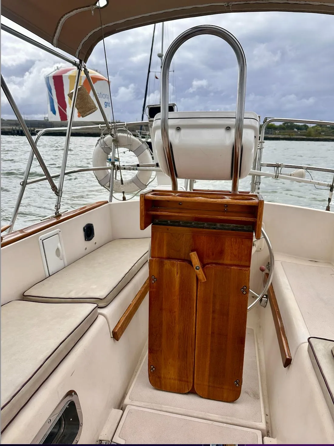 1987 Island Packet 31 sailboat cockpit with wooden helm and seating.