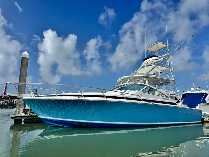 Island Time Yacht Photos Pics 1997 Bertram 36 Moppie boat docked under a clear blue sky.