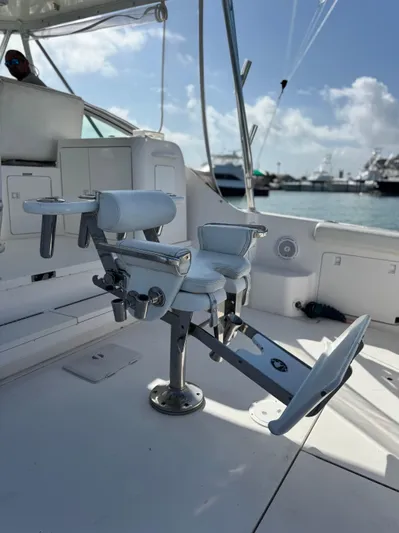 Island Time Yacht Photos Pics Fishing chair on a 1997 Bertram 36 Moppie yacht, docked with clear skies.