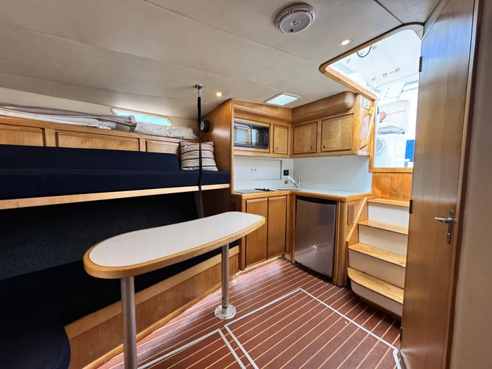 Island Time Yacht Photos Pics Interior of a 1997 Bertram 36 Moppie yacht with wood cabinetry and modern amenities.