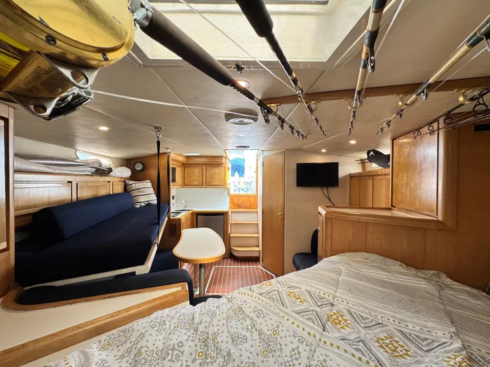 Island Time Yacht Photos Pics Interior of a 1997 Bertram 36 Moppie boat with cozy seating and fishing rods.