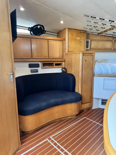 Island Time Yacht Photos Pics Interior of 1997 Bertram 36 Moppie yacht with wooden cabinets and blue seating.