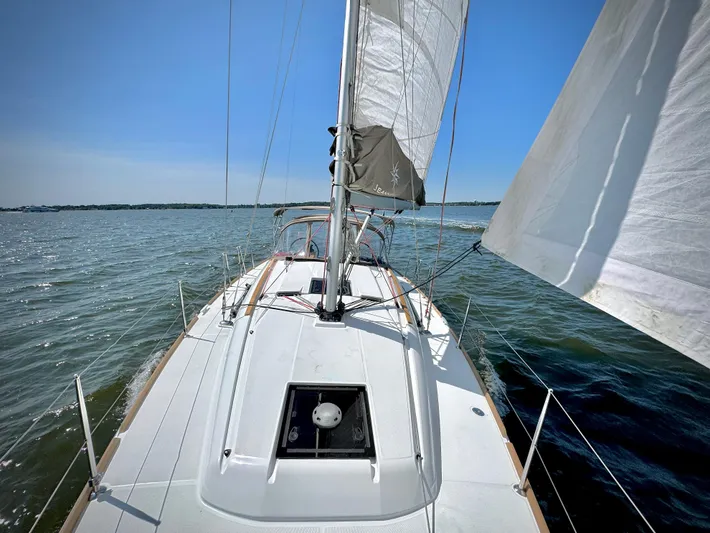 Glide Away Yacht Photos Pics 2015 Jeanneau Sun Odyssey 379 sailing on open water under clear blue skies.