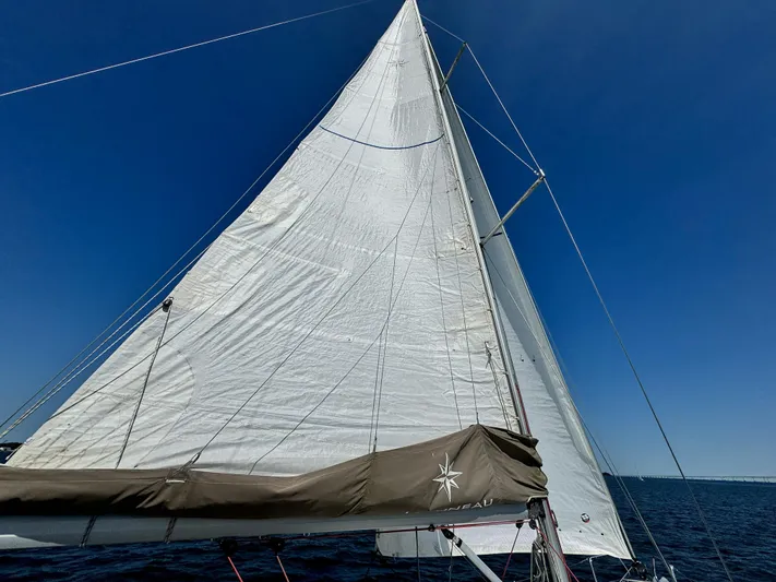 Glide Away Yacht Photos Pics Jeanneau Sun Odyssey 379 sailboat, 2015 model, sailing under clear blue sky.