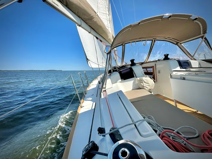 Glide Away Yacht Photos Pics 2015 Jeanneau Sun Odyssey 379 sailing on open water under clear blue skies.