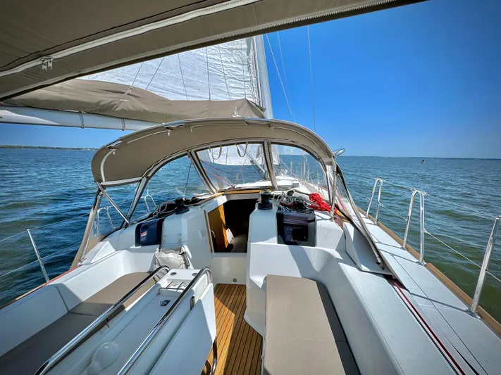 Glide Away Yacht Photos Pics 2015 Jeanneau Sun Odyssey 379 sailboat on open water, featuring spacious cockpit and sails.