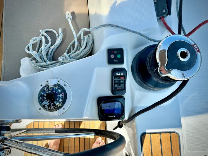 Glide Away Yacht Photos Pics Cockpit controls of 2015 Jeanneau Sun Odyssey 379 sailboat, featuring navigation instruments and winch.