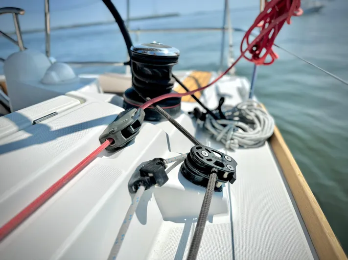 Glide Away Yacht Photos Pics Close-up of Jeanneau Sun Odyssey 379 sailboat deck, showcasing winches and ropes, 2015 model.