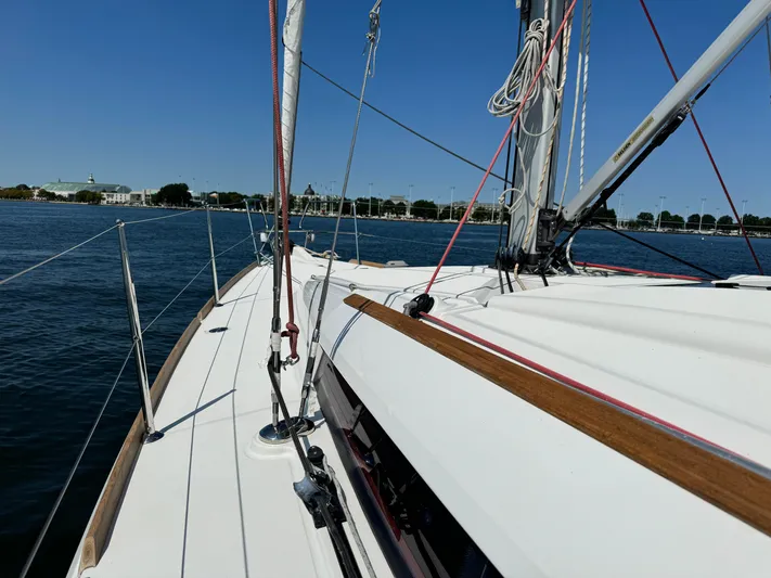 Glide Away Yacht Photos Pics Jeanneau Sun Odyssey 379 sailboat deck, 2015 model, sailing on calm waters.