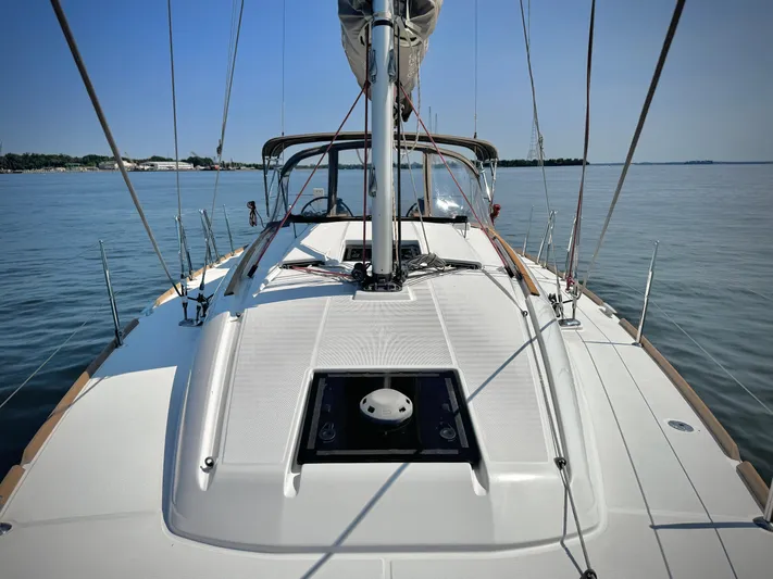 Glide Away Yacht Photos Pics 2015 Jeanneau Sun Odyssey 379 sailboat deck on calm water.