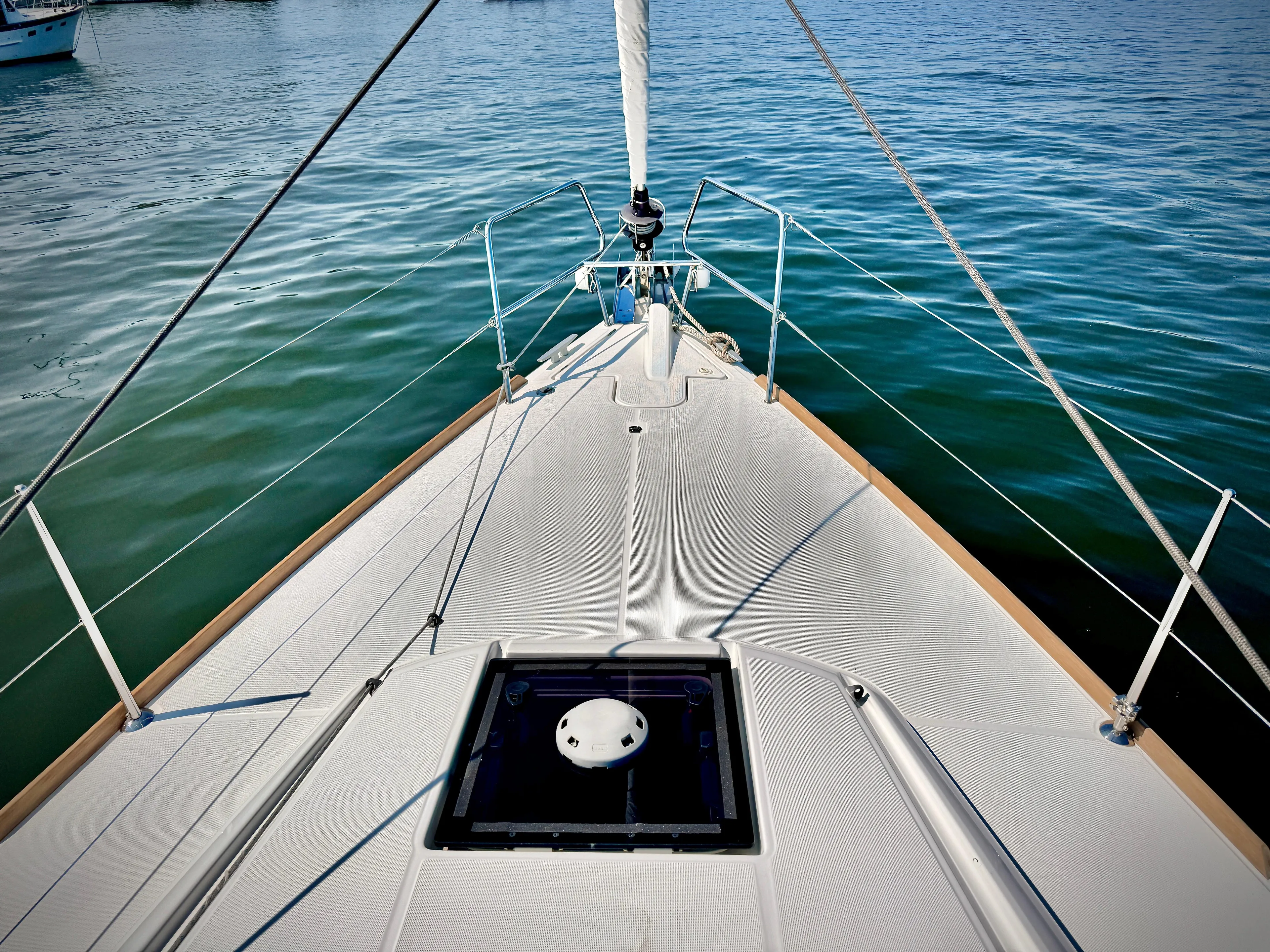 Glide Away Yacht Photos Pics Bow view of 2015 Jeanneau Sun Odyssey 379 sailboat on calm water.