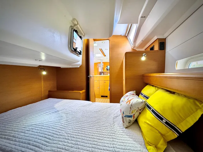 Glide Away Yacht Photos Pics Cozy cabin interior of 2015 Jeanneau Sun Odyssey 379 sailboat with bright bedding.