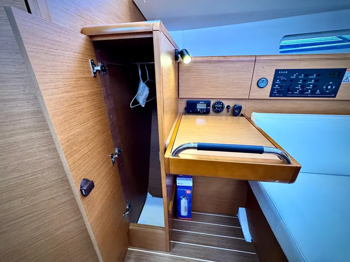 Glide Away Yacht Photos Pics Interior of 2015 Jeanneau Sun Odyssey 379 sailboat with navigation panel and storage.