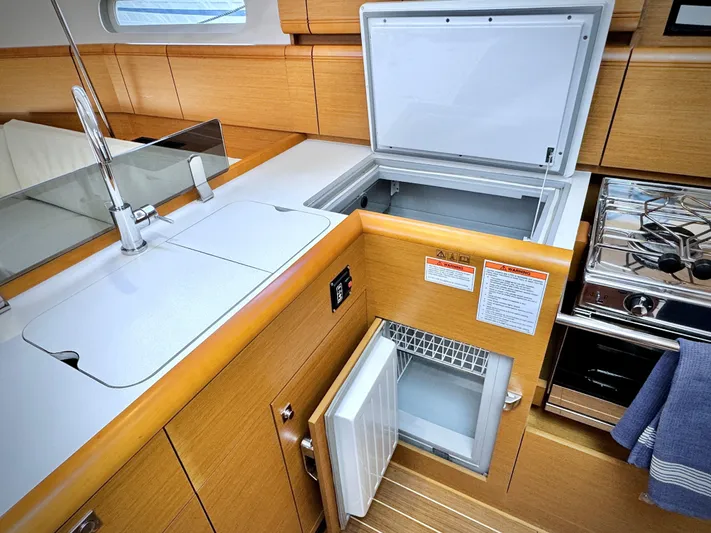 Glide Away Yacht Photos Pics Modern kitchen in 2015 Jeanneau Sun Odyssey 379 yacht with open fridge and stove.