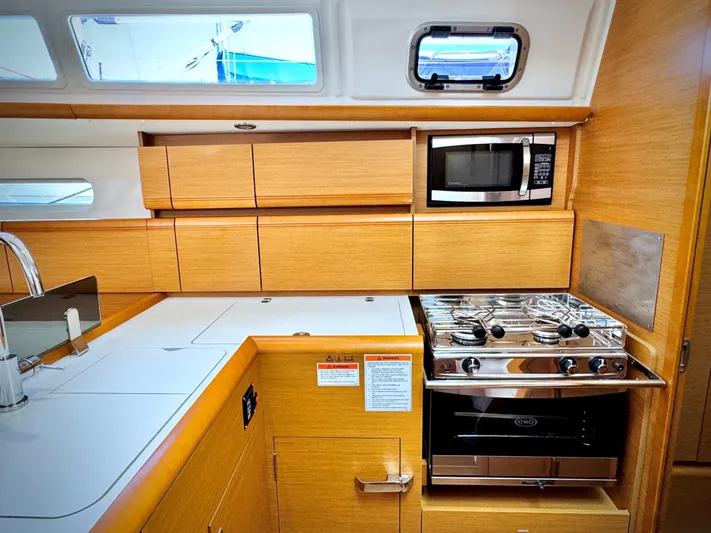 Glide Away Yacht Photos Pics Modern kitchen in 2015 Jeanneau Sun Odyssey 379 yacht with stove and microwave.