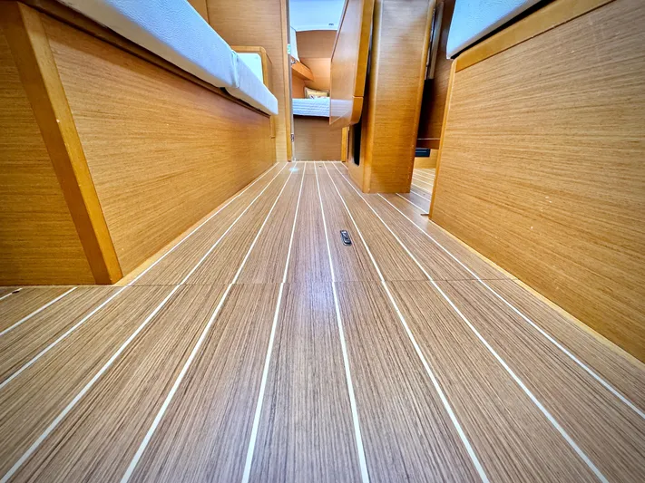 Glide Away Yacht Photos Pics Interior view of 2015 Jeanneau Sun Odyssey 379 sailboat with wooden flooring.