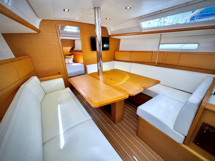 Glide Away Yacht Photos Pics Interior of 2015 Jeanneau Sun Odyssey 379 sailboat with modern seating and wooden finishes.