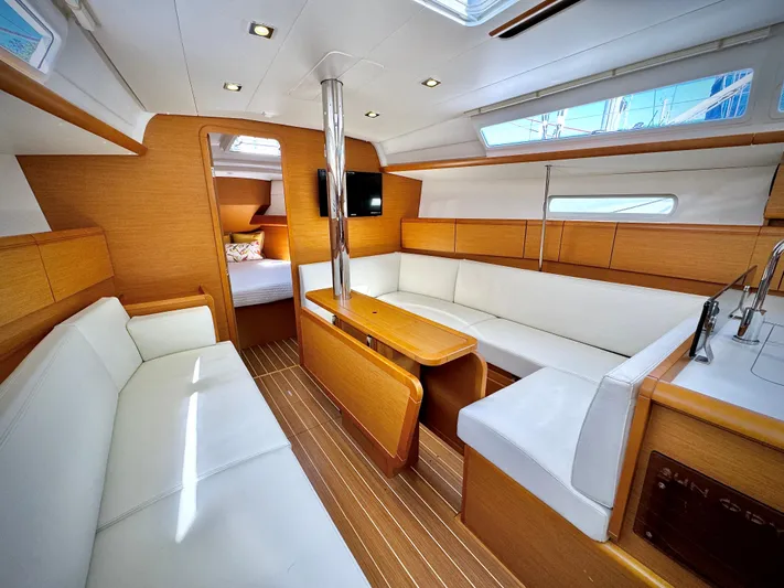 Glide Away Yacht Photos Pics Interior of 2015 Jeanneau Sun Odyssey 379 yacht with modern seating and wood finish.