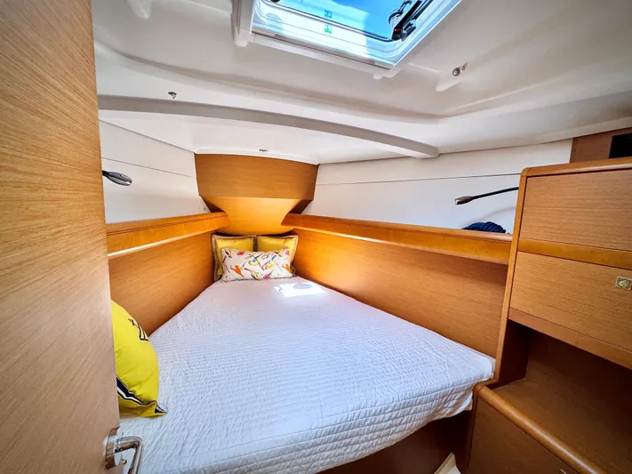Glide Away Yacht Photos Pics Cozy cabin interior of 2015 Jeanneau Sun Odyssey 379 sailboat with skylight and wooden finish.