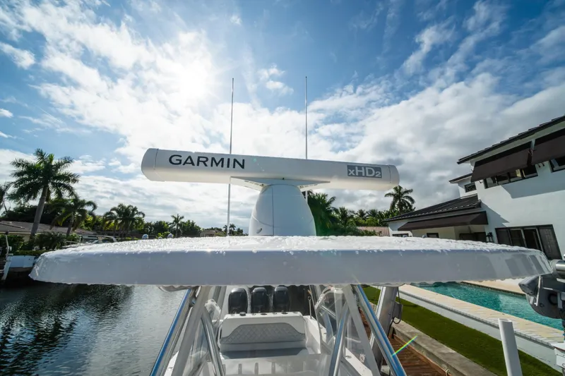 Carried Away Yacht Photos Pics 2016 Invincible 36 Open Fisherman with Garmin xHD2 radar, docked by a canal under a sunny sky.