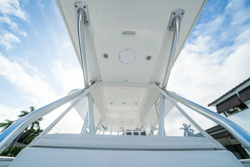 Carried Away Yacht Photos Pics 2016 Invincible 36 Open Fisherman boat, view of the T-top and railings against a blue sky.