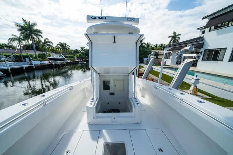 Carried Away Yacht Photos Pics 2016 Invincible 36 Open Fisherman boat docked by a canal, featuring Garmin electronics.