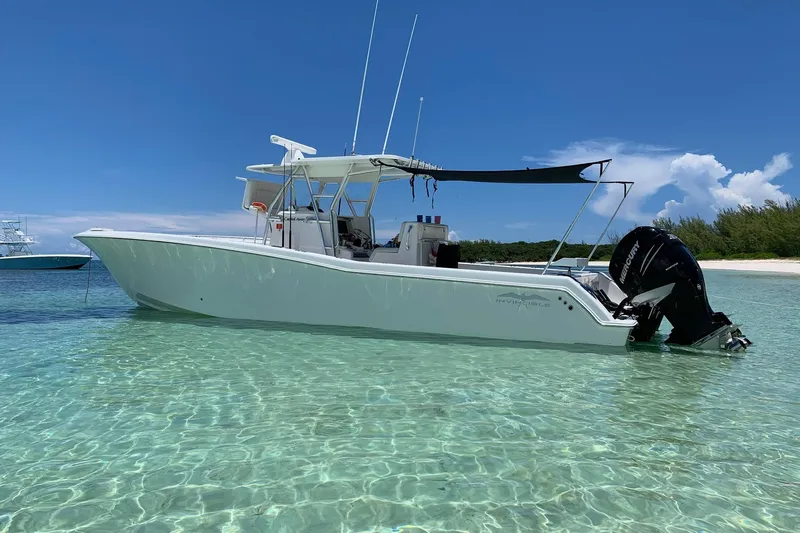 Carried Away Yacht Photos Pics 2016 Invincible 36 Open Fisherman boat in clear shallow water, sunny day.