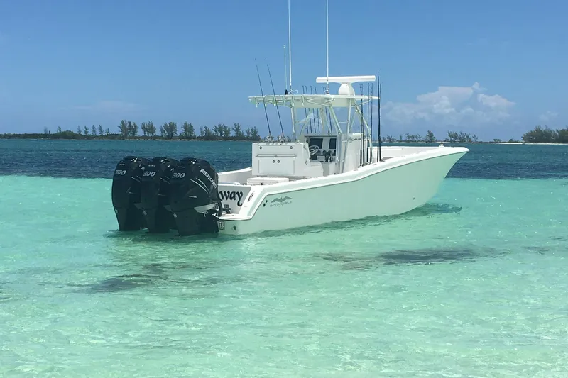 Carried Away Yacht Photos Pics 2016 Invincible 36 Open Fisherman boat in clear turquoise water.