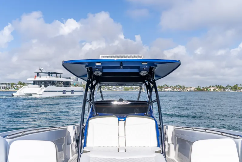 Work From Home Yacht Photos Pics 2024 Nor-Tech 390 Sport boat on water, featuring sleek design and spacious seating.