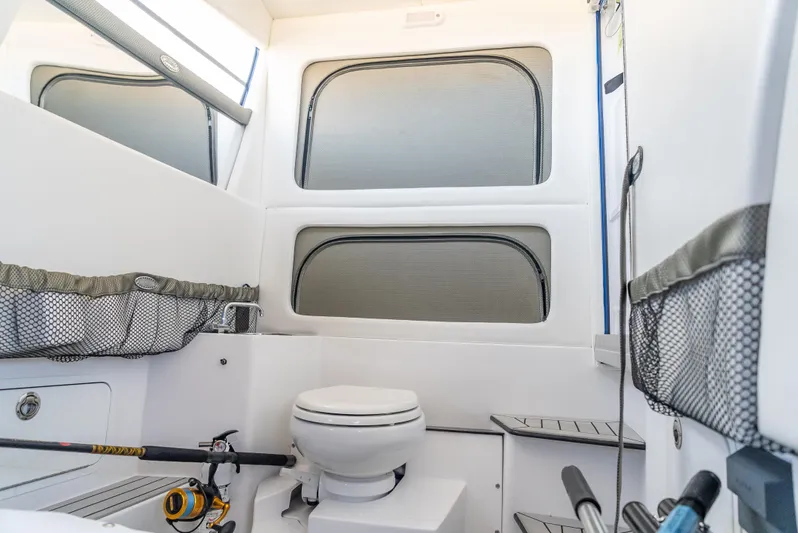 Work From Home Yacht Photos Pics 2024 Nor-Tech 390 Sport interior cabin with toilet and fishing gear storage.