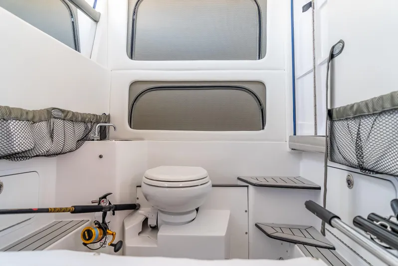 Work From Home Yacht Photos Pics 2024 Nor-Tech 390 Sport boat interior with toilet and fishing gear storage.