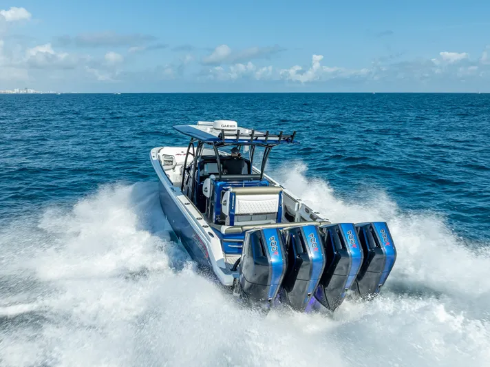 Work From Home Yacht Photos Pics 2024 Nor-Tech 390 Sport boat cruising on open ocean with powerful engines.