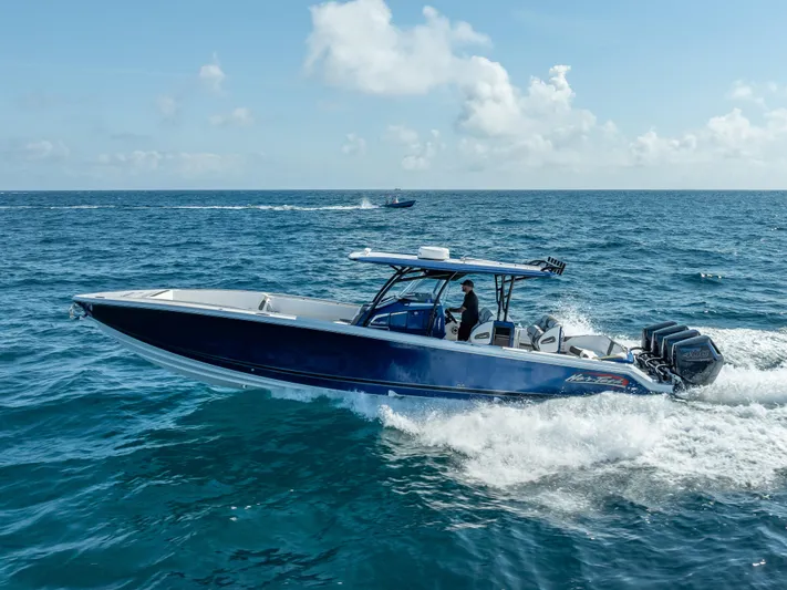 Work From Home Yacht Photos Pics 2024 Nor-Tech 390 Sport boat cruising on open ocean under clear skies.