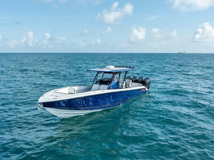 Work From Home Yacht Photos Pics 2024 Nor-Tech 390 Sport boat cruising on open ocean under clear skies.