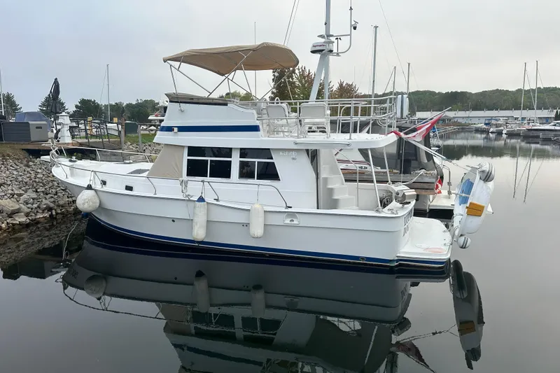 Lucky Dog Yacht Photos Pics 2002 Mainship 390 Trawler docked in a serene marina setting.