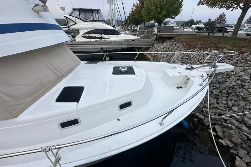Lucky Dog Yacht Photos Pics 2002 Mainship 390 Trawler docked at marina, showcasing bow and deck features.
