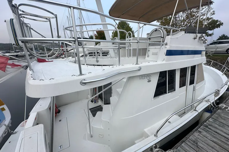 Lucky Dog Yacht Photos Pics 2002 Mainship 390 Trawler docked, showcasing upper deck and railing details.