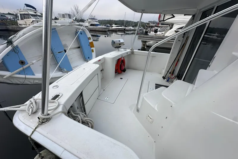 Lucky Dog Yacht Photos Pics 2002 Mainship 390 Trawler deck view at marina, featuring clean layout and safety equipment.