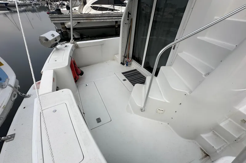 Lucky Dog Yacht Photos Pics 2002 Mainship 390 Trawler deck with stairs and marina view.