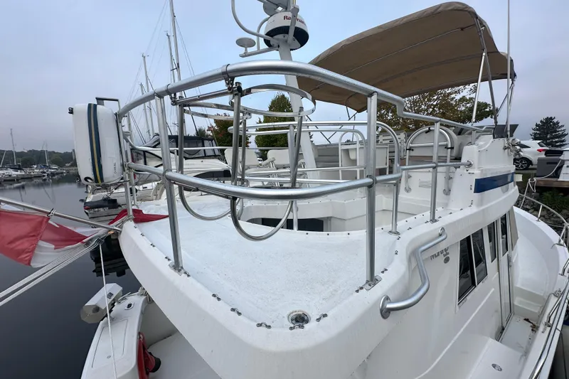 Lucky Dog Yacht Photos Pics 2002 Mainship 390 Trawler docked at marina, featuring upper deck and railing.
