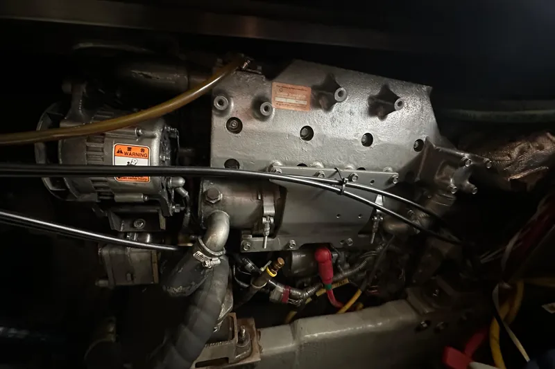 Lucky Dog Yacht Photos Pics Engine compartment of a 2002 Mainship 390 Trawler, showcasing mechanical components and wiring.