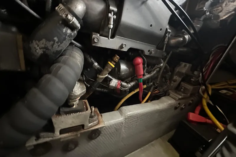 Lucky Dog Yacht Photos Pics Engine compartment of a 2002 Mainship 390 Trawler, showcasing hoses and wiring.