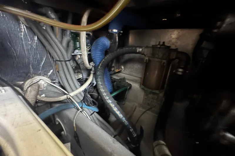 Lucky Dog Yacht Photos Pics Engine compartment of a 2002 Mainship 390 Trawler, showcasing hoses and wiring.