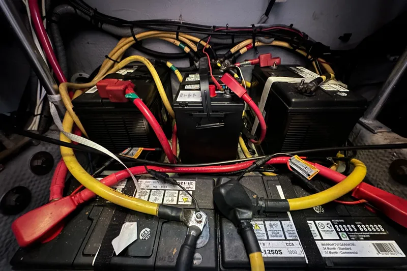 Lucky Dog Yacht Photos Pics Battery compartment of a 2002 Mainship 390 Trawler with cables and connections.