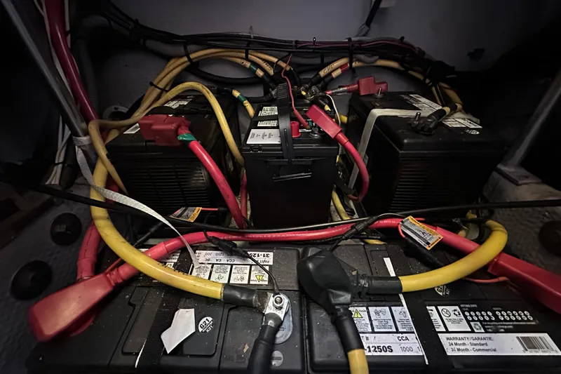 Lucky Dog Yacht Photos Pics Battery compartment of a 2002 Mainship 390 Trawler with cables and connections.