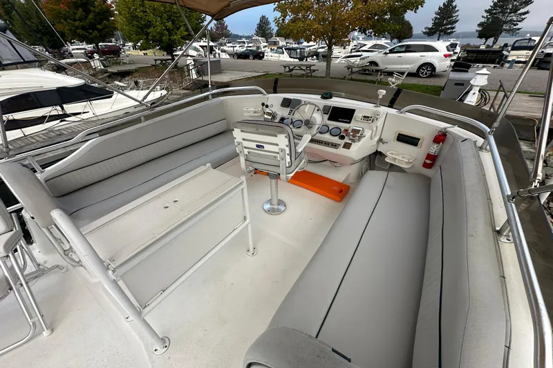 Lucky Dog Yacht Photos Pics 2002 Mainship 390 Trawler cockpit with seating, steering wheel, and control panel.