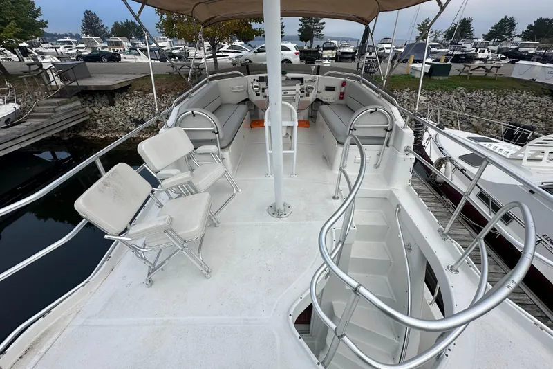 Lucky Dog Yacht Photos Pics 2002 Mainship 390 Trawler flybridge with seating, docked at marina.
